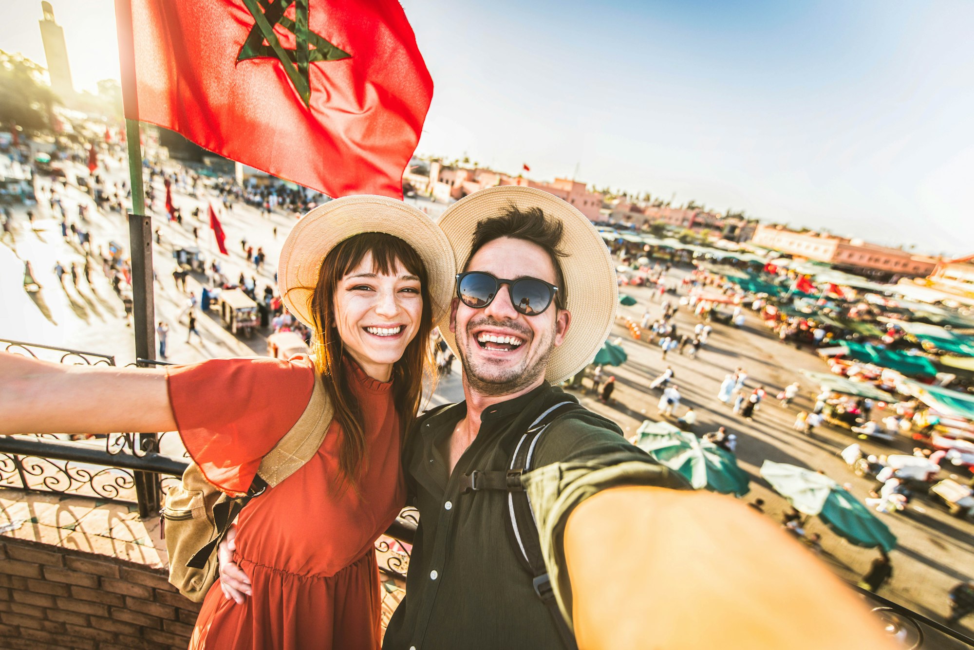 Happy tourists couple visiting Jamaa el-Fna market Marrakech, Morocco