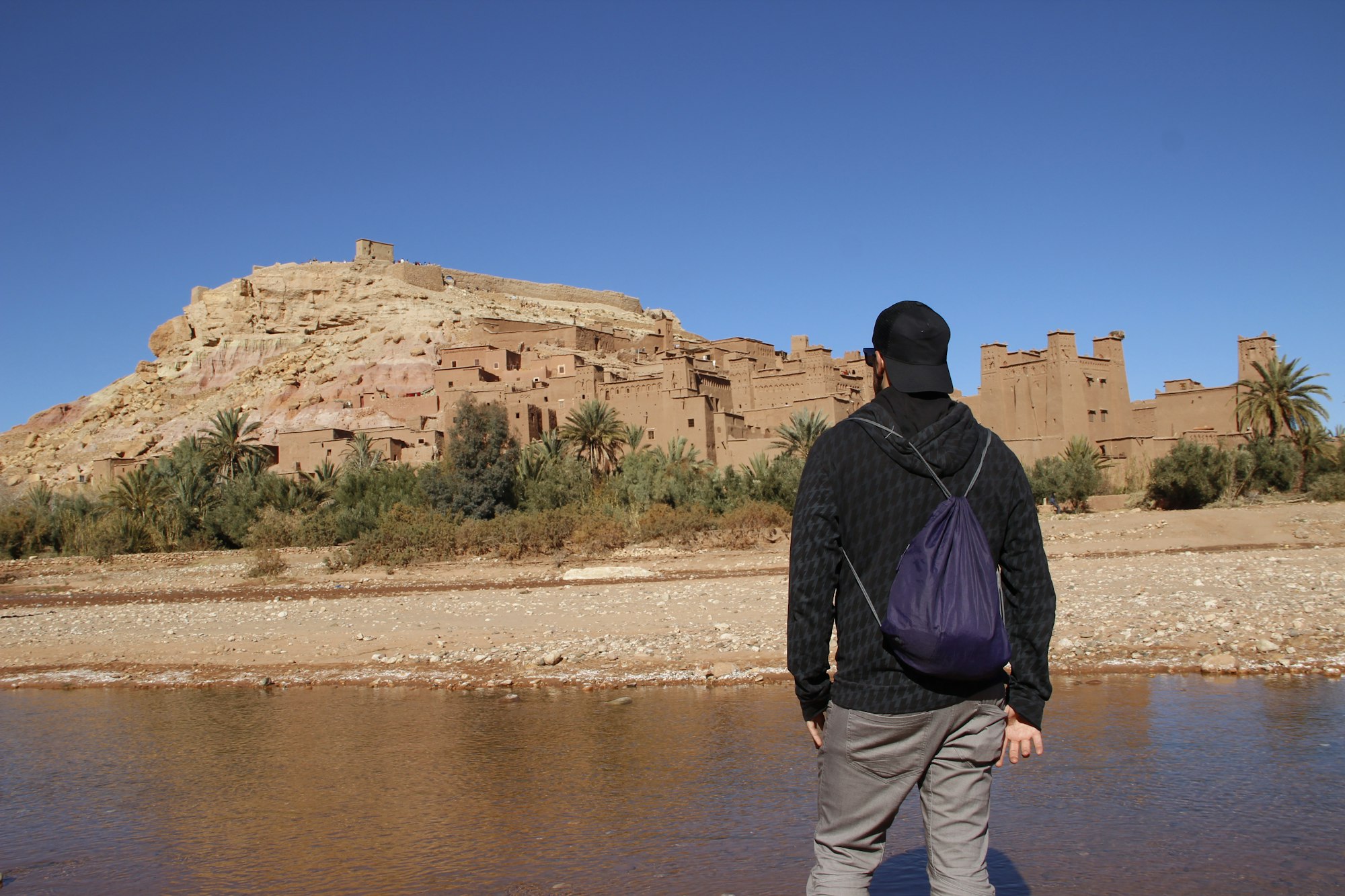 A young man watching Ksar Ait Ben Haddou, Ksar Ait Ben Haddou, Morocco