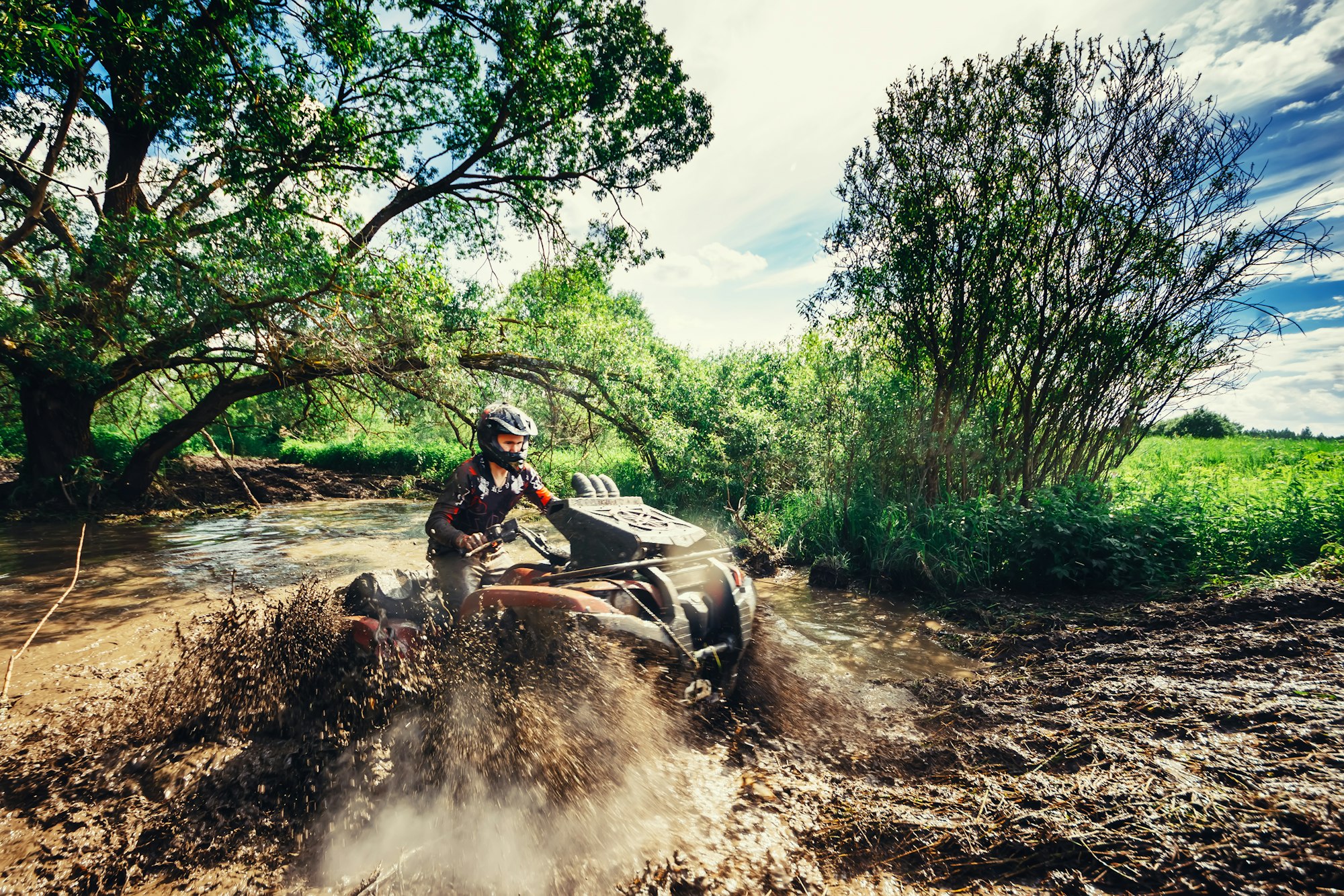 Man on the ATV Quad Bike running in mud track