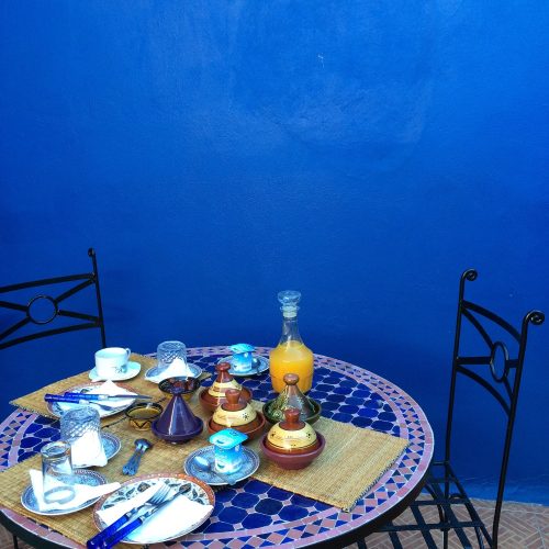 Breakfast in Blue, having breakfast in Morocco in front of a blue wall, table with mosaic tiles