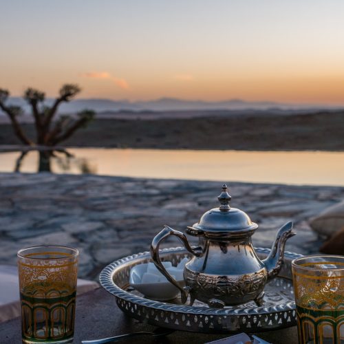 closeup shot of a typical Moroccan mint tea set on the table in Agafay desert, Marrakech