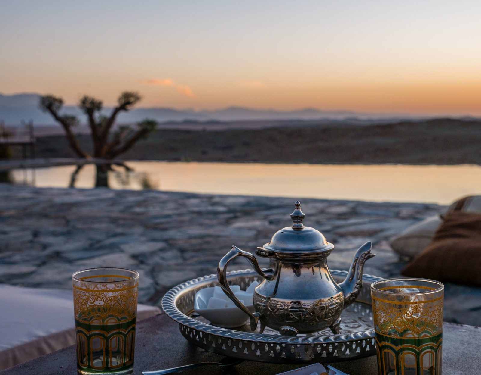 closeup shot of a typical Moroccan mint tea set on the table in Agafay desert, Marrakech