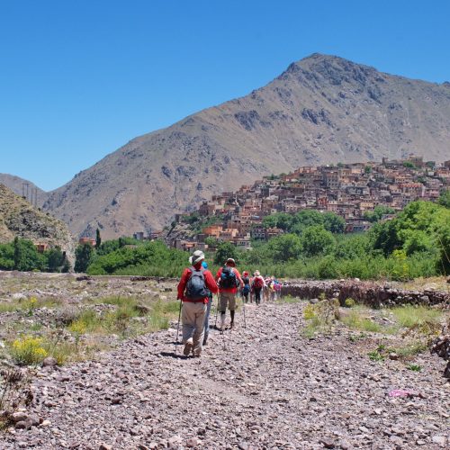 Hiking in High Atlas mountains in Morocco. Townscape of Imlil in the background